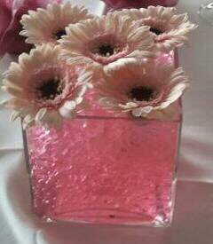 Cube venue table displays with gerbera